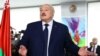 Belarusian President Alexander Lukashenko votes during the presidential election in Minsk