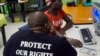 FILE - An outreach officer shares some of her experiences with a visitor at the local charity Gender Dynamix, at its offices in Athlone, near Cape Town, South Africa, Nov. 16, 2012. Botwana recently followed South Africa in allowing a gender identity change. 