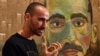 Artist Mostafa Azimitabar is pictured in front of his work, titled 'Self-Portrait,' as the finalists' work for the Archibald Prize is displayed in Sydney on May 5, 2022. 