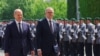 German Chancellor Olaf Scholz and Australian Prime Minister Anthony Albanese review the troops in the yard of the Chancellery in Berlin, Germany, July 10, 2023. 