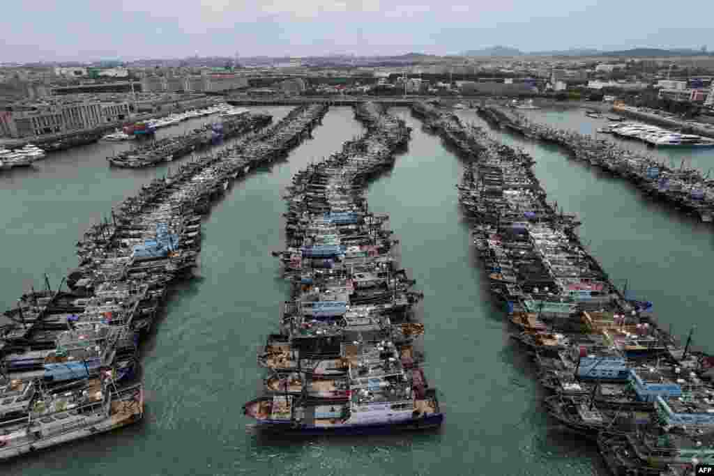Fishing boats are moored at a port in China's Gaoqi locality of Xiamen city at Fujian province in preparation for the approaching Typhoon Doksuri.