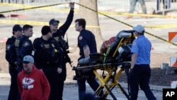 Emergency personnel arrive following a shooting at the Kansas City Chiefs NFL football Super Bowl celebration in Kansas City, Mo., Feb. 14, 2024. Twenty-two people were hit by gunfire, and one died, authorities said.