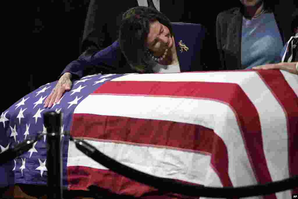 U.S. Rep. Nancy Pelosi, D-Calif., puts her arm around the casket of the late Sen. Dianne Feinstein at City Hall, Oct. 4, 2023, in San Francisco. Feinstein's body will lie in state at San Francisco City Hall. Feinstein, who died Sept. 29, served as San Francisco's mayor. 
