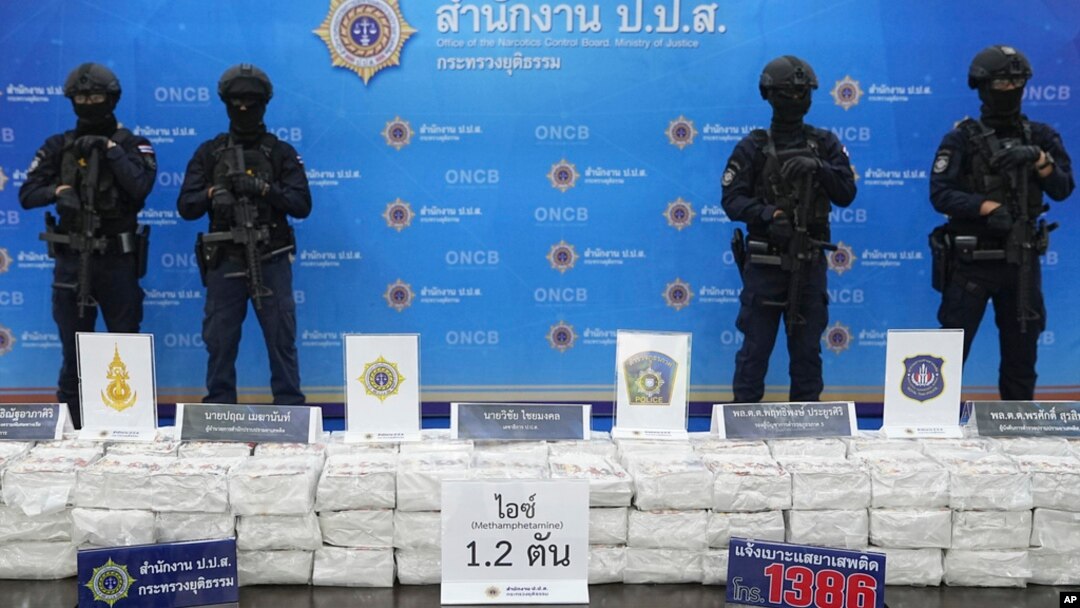 Police officers stand behind seized crystal methamphetamine during a news conference in Bangkok, Thailand, May 29, 2023.