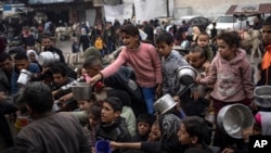 Palestinians line up for a free meal in Rafah, Gaza Strip, Dec. 21, 2023.