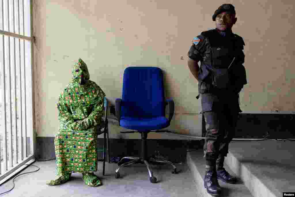 A masked witness is seen before testifying in front of the military court at the trial of six soldiers accused of the murder of 56 civilians during a demonstration against the presence of United Nations Organization Stabilization Mission in the Democratic Republic of the Congo (MONUSCO) and East Africa Community Regional Force (EACRF) at the military auditorium in Goma, North Kivu province, Sept. 15, 2023. 