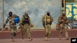 This undated photo provided by the French military shows three Russian mercenaries in northern Mali. 