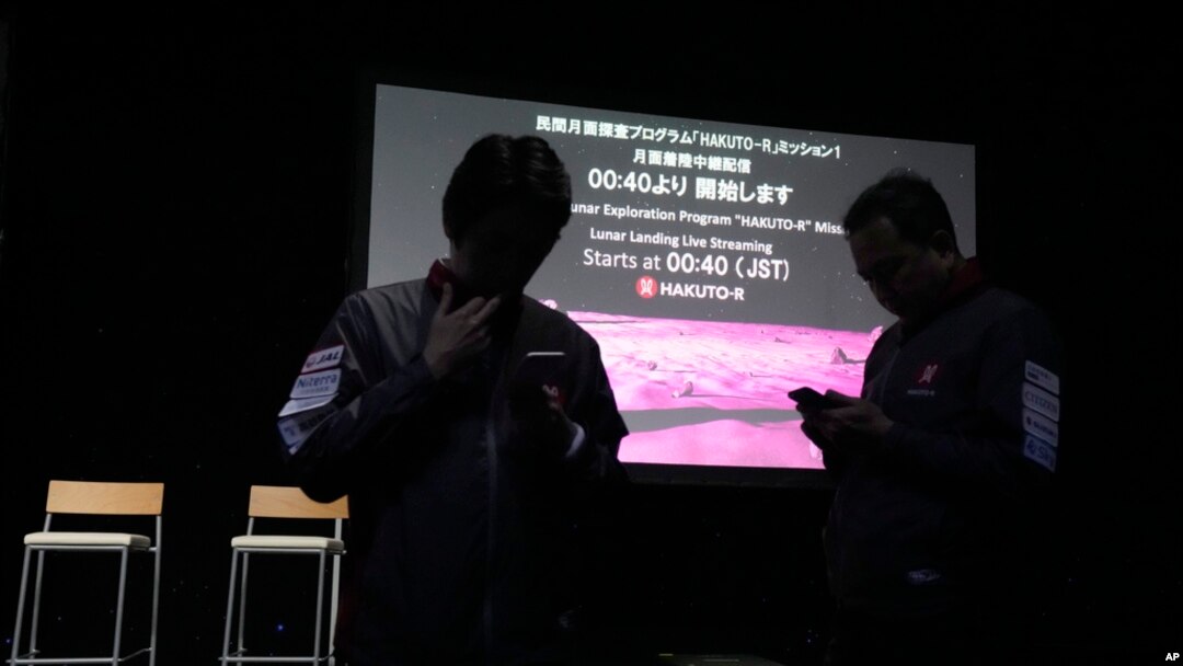 Staff stand in front of the screen prior to a planned livestream of the lunar landing event, at Miraikan, the National Museum of Emerging Science and Innovation, in Tokyo, April 26, 2023.