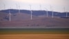 A fence is seen in front of wind turbines that are part of the Infigen Energy Capital Wind Farm located on the hills surrounding Lake George, near the Australian capital city of Canberra, Australia Feb. 21, 2018. 