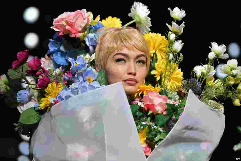 Model Gigi Hadid presents a creation for fashion house Moschino during the Women's Spring/Summer 2018 fashion shows in Milan, Italy.