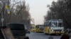 Evacuation buses carrying internally displaced people arrive at an IDP center in Zaporizhzhia, Ukraine, March 25, 2022.