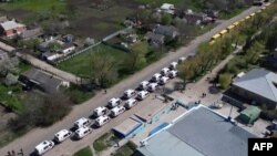 FILE - This video grab taken from a handout footage released by the Russian Defense Ministry on May 2, 2022 shows civilians being evacuated from an area near the Azovstal steel plant in Mariupol.