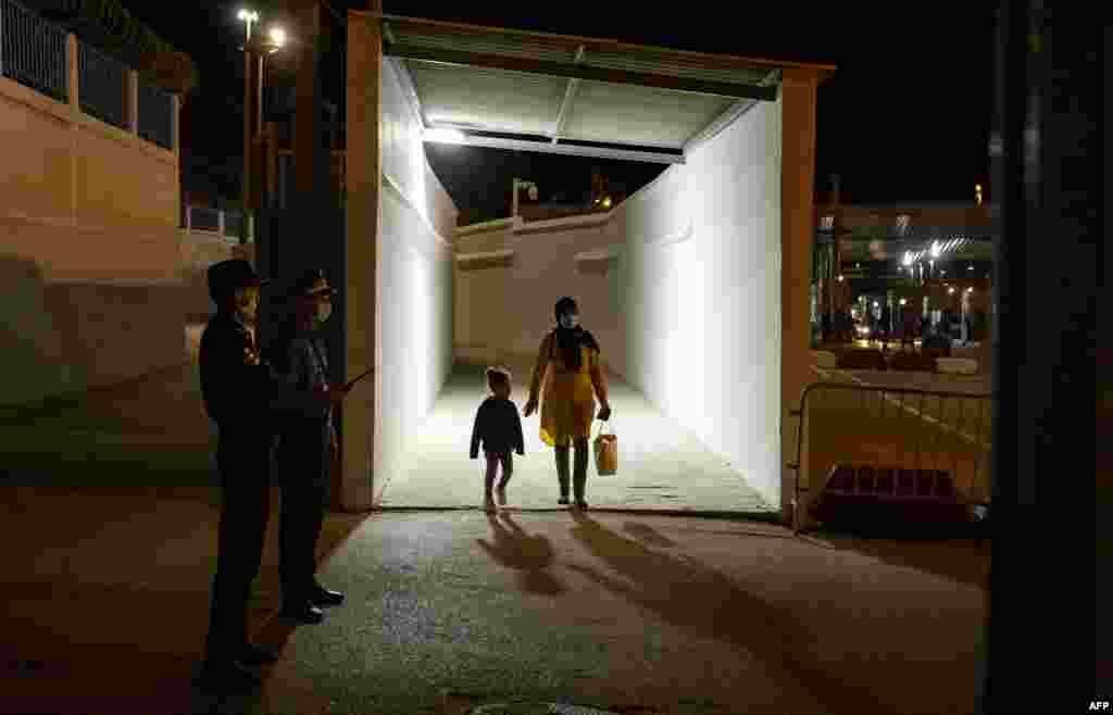 People arrive in Fnideq, Morocco, after crossing in from the Spanish enclave of Ceuta as the land border between Morocco and Spain reopens after two years. 