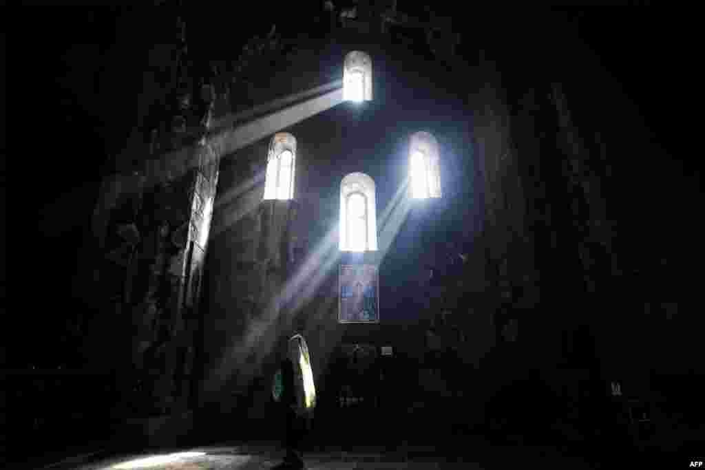 A woman prays in the Sts. Paul and Peter church at the 9th century Tatev monastery of the Armenian Apostolic Church, some 270 km of Yerevan, Armenia.