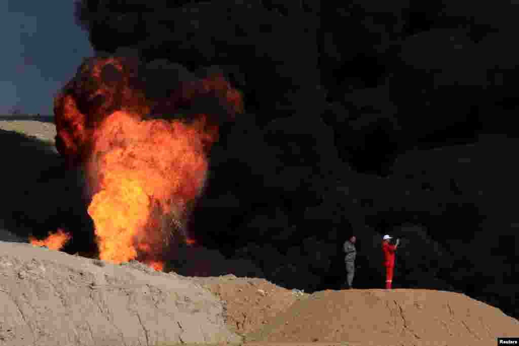Smoke rises from oil wells, in Dibis area on the outskirts of Kirkuk, Iraq, Oct. 17, 2017.