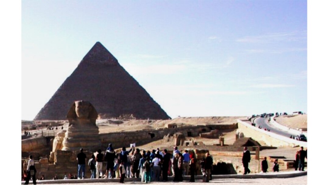 FILE - Tourists are gathering around the Sphinx, which guards the Great Pyramid of King Cheops, home of the ancient wooden solar boat, at the Giza necropolis just outside Cairo, Egypt. (photo: Diaa Bekheet)