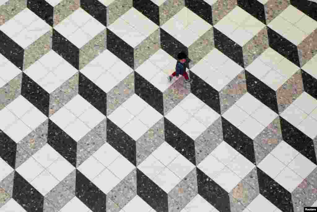 A boy walks at a shopping mall in Tokyo, Japan.