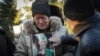 The mother of writer Volodymyr Vakulenko mourns near his grave on Dec. 6, 2022, after he died during the Russian occupation of Kharkiv, Ukraine. The U.S. Congress is considering the White House’s request to give Ukraine $38 billion more in aid to defend itself against Russia.