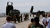 Фото: американська система HIMARS та японська 12SSM на виставці в Японії, червень 2022 року. REUTERS/Issei Kato
