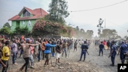 FILE - Demonstrators clash with police during a protest against the United Nations peacekeeping force MONUSCO deployed in the Democratic Republic of the Congo, in Sake, some 24 kilometers west of Goma, July 27, 2022.