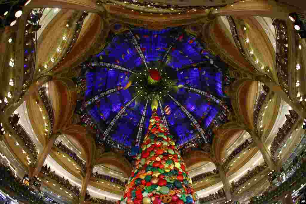 A giant Christmas tree stands in the center dome as Singer Beth Ditto performs to inaugurate the Christmas season at the Galeries Lafayette department store in Paris, France, Nov. 8, 2017.