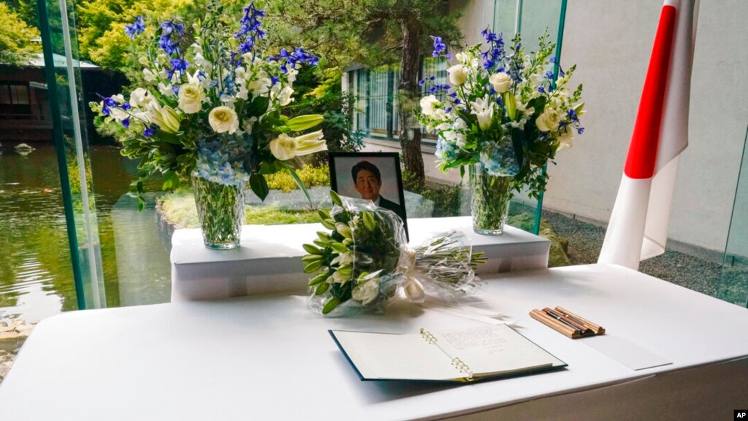 A condolence book open to the page President Joe Biden signed for former Japanese Prime Minister Shinzo Abe, who was assassinated Friday, rests on a table at the Japanese ambassador's residence in Washington, July 8, 2022.
