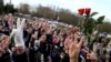 People flash the V-sign to pay tribute to late opposition protester Raman Bandarenka during his funeral ceremony in Minsk, Belarus on November 20, 2020.