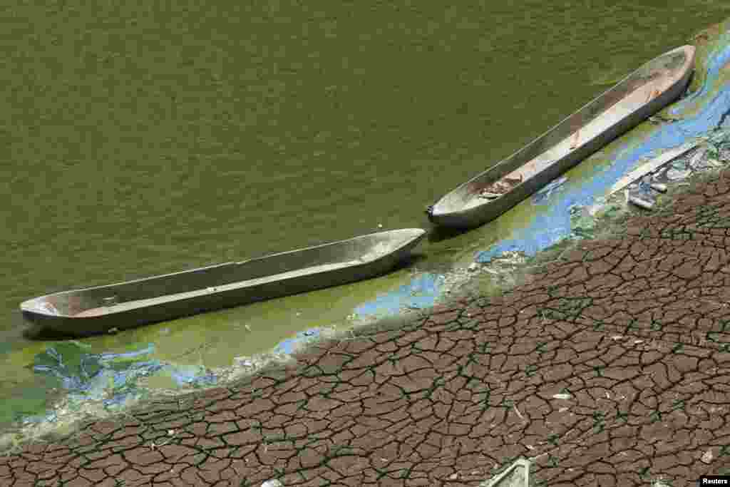 Wooden boats sit at the base of a dried-up reservoir, due to the long dry season, at Kedung Sumber village, near Bojonegoro, Indonesia's East Java province.