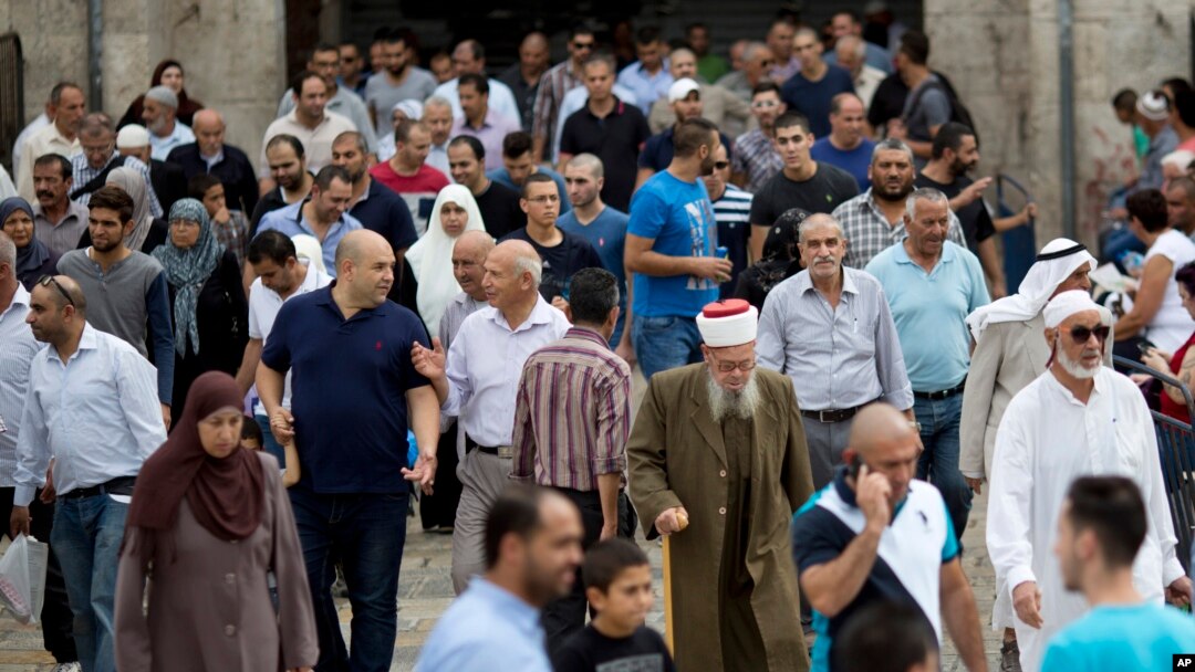 FILE - Palestinian Muslim worshippers walk in Jerusalem's Old City after Friday prayers, Oct. 23, 2015.