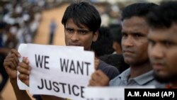 Rohingya refugees holding placards, await the arrival of a U.N. Security Council team at the Kutupalong Rohingya refugee camp in Kutupalong, Bangladesh, on April 29, 2018.