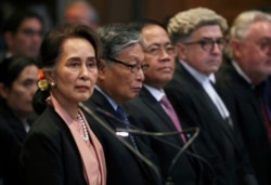 FILE - Aung San Suu Kyi attends a hearing in a case filed by Gambia against Myanmar alleging genocide against the minority Muslim Rohingya population, at the International Court of Justice, Dec.10, 2019.