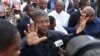 FILE - Joao Lourenco shows his ink-stained finger as he faces the media after casting his vote in elections in Luanda, Angola, Aug. 23, 2017.