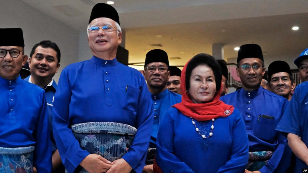 FILE - Former Malaysian Prime Minister Najib Razak, second left in front, and his wife Rosmah Mansor prepare to leave for an election nomination center in Pekan, Pahang state, Malaysia, April 28, 2018. 