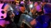 Montenegrin police officers block the street during a protest in Niksic, Montenegro, Wednesday, May 13, 2020. Montenegrin police used tear gas to disperse protests demanding the release of eight Serbian Orthodox Church priests who were detained for…