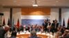 Members of the international committee take their seats for a follow-up meeting on Libya, arranged by German Foreign Minister Heiko Maas, in Munich, Germany, Feb. 16, 2020. 