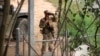 FILE - In this April 10, 2018, file frame from video, a National Guard troop watches over Rio Grande River on the border in Roma, Texas. 