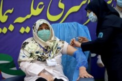 A member of the Imam Khomeini Hospital medical personnel receives a dose of Russia’s Sputnik V vaccine against the coronavirus disease (COVID-19), in Tehran, Iran on Tuesday, Feb. 9, 2021.