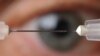 A microneedle used to inject glaucoma medications into the eye is shown next to a conventional hypodermic needle. (Georgia Tech Photo: Gary Meek)
