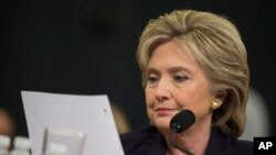 FILE - Democratic presidential candidate, former Secretary of State Hillary Rodham Clinton looks at an email sent by Ambassador Chris Stevens during her testimony before the House Benghazi Committee.