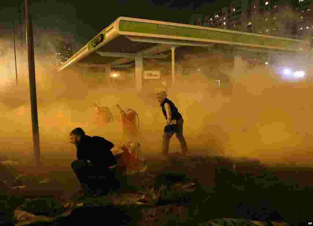 Protesters set off a fire extinguisher toward a petrol station under construction in a densely populated area in Kyiv, Ukraine, Oct. 4, 2017.