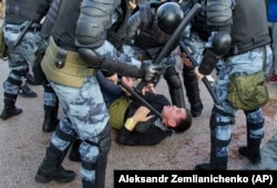 RUSSIA -- Police officers detain a person during a rally in Moscow, July 27, 2019