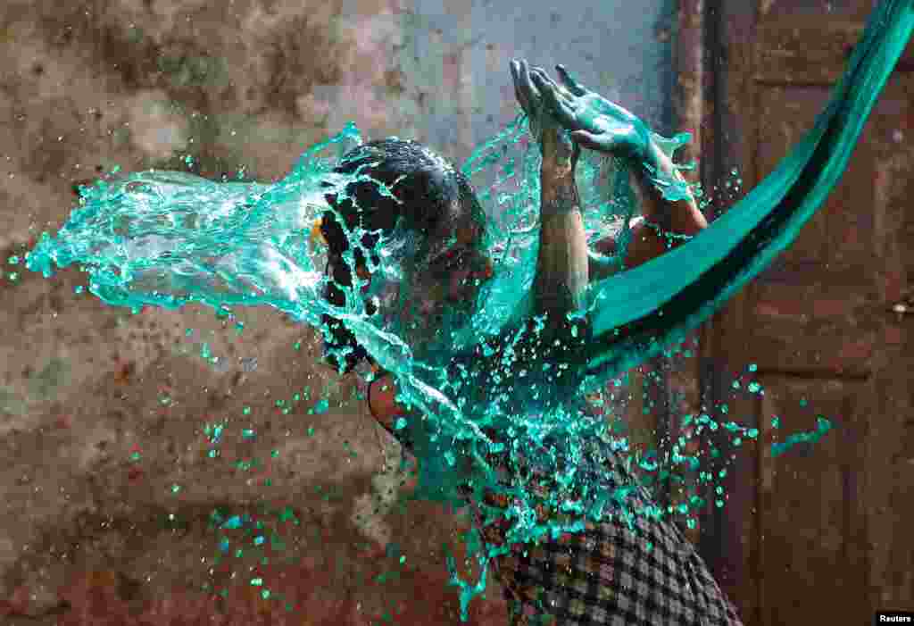 A girl reacts as colored water is thrown on her face while celebrating Holi, the Festival of Colors, in Mumbai, India, March 13, 2017.