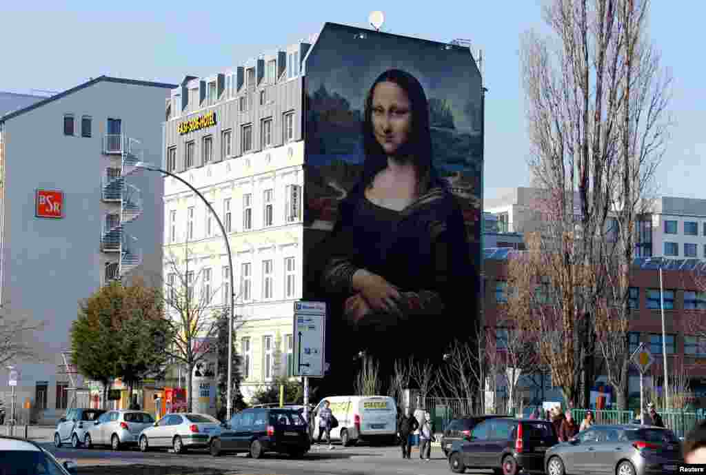 A mural by Berlin-based street art gang "Die Dixons" (The Dixons) which features a giant reproduction of Leonardo da Vinci's artwork Mona Lisa, is seen near East Side Gallery in Berlin, Germany.