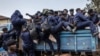 Congolese police officers board trucks for redeployment following an enrollment of civilians, police officers, and former members of the Armed Forces of the Democratic Republic of Congo (FARDC) who allegedly decided to join the M23 movement voluntarily in