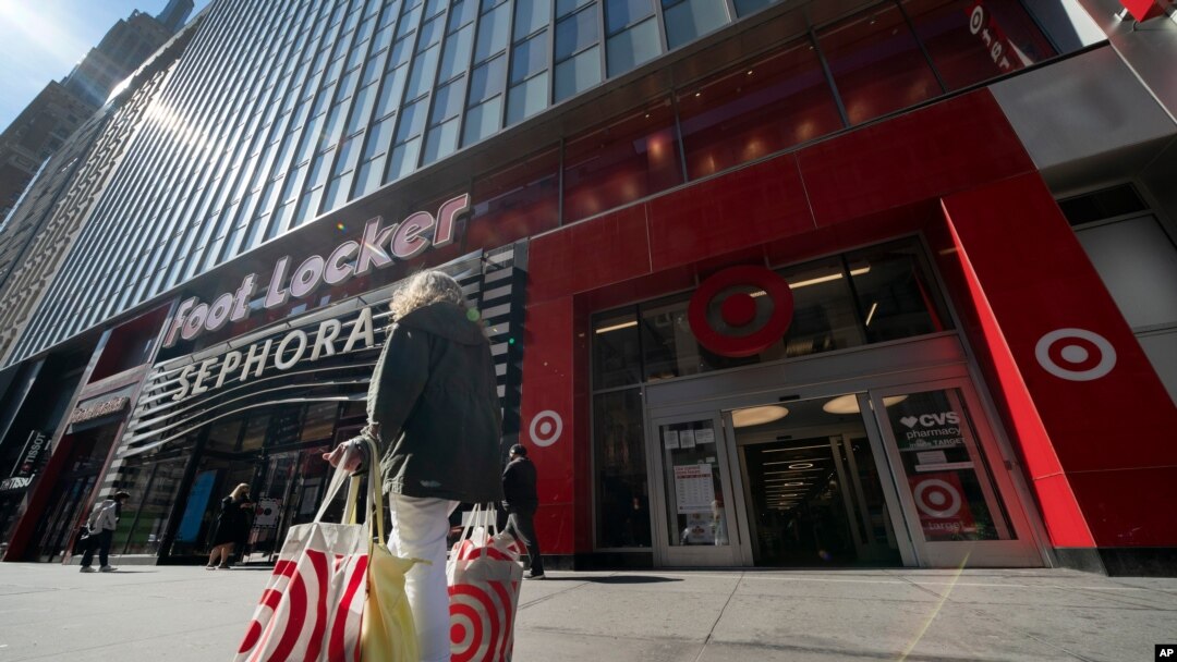 A woman carries Target shopping bags as she leaves the store, April 19, 2021 in New York.