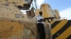 FILE - A Somali traffic policeman stands guard near the scene of a suicide car bomb explosion outside the traffic police headquarters in Somalia's capital Mogadishu. Abukar Arman, the former Special Representative of Somalia to Washington, said Wednesday the United States has been weak in using “soft power” in its effort to support the government attain security and political stability.