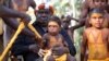 Yunupingu, an influential Australian Indigenous leader, is seen holding a child in this 2019 handout photo in Australia. Peter Eve/Yothu Yindi Foundation/Handout via REUTERS