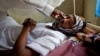 FILE - A patient with hepatitis is treated at a hospital in El Sereif village, North Darfur, Sudan, May 13, 2013.