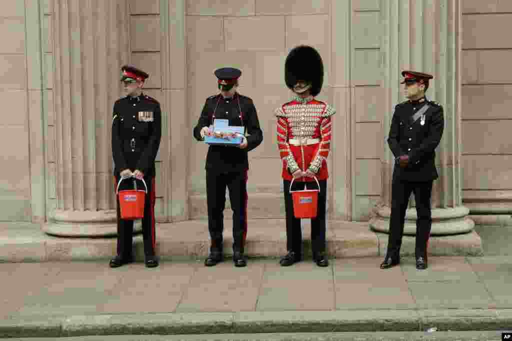 Members of the British military's Honorable Artillery Company collect donations for the annual poppy appeal ahead of Armistice Day, outside the Bank of England in London.