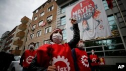 A demonstrator, wearing a face mask and shield for protection againstcoronavirus, chants slogans during May Day protests in Istanbul, May 1, 2020.